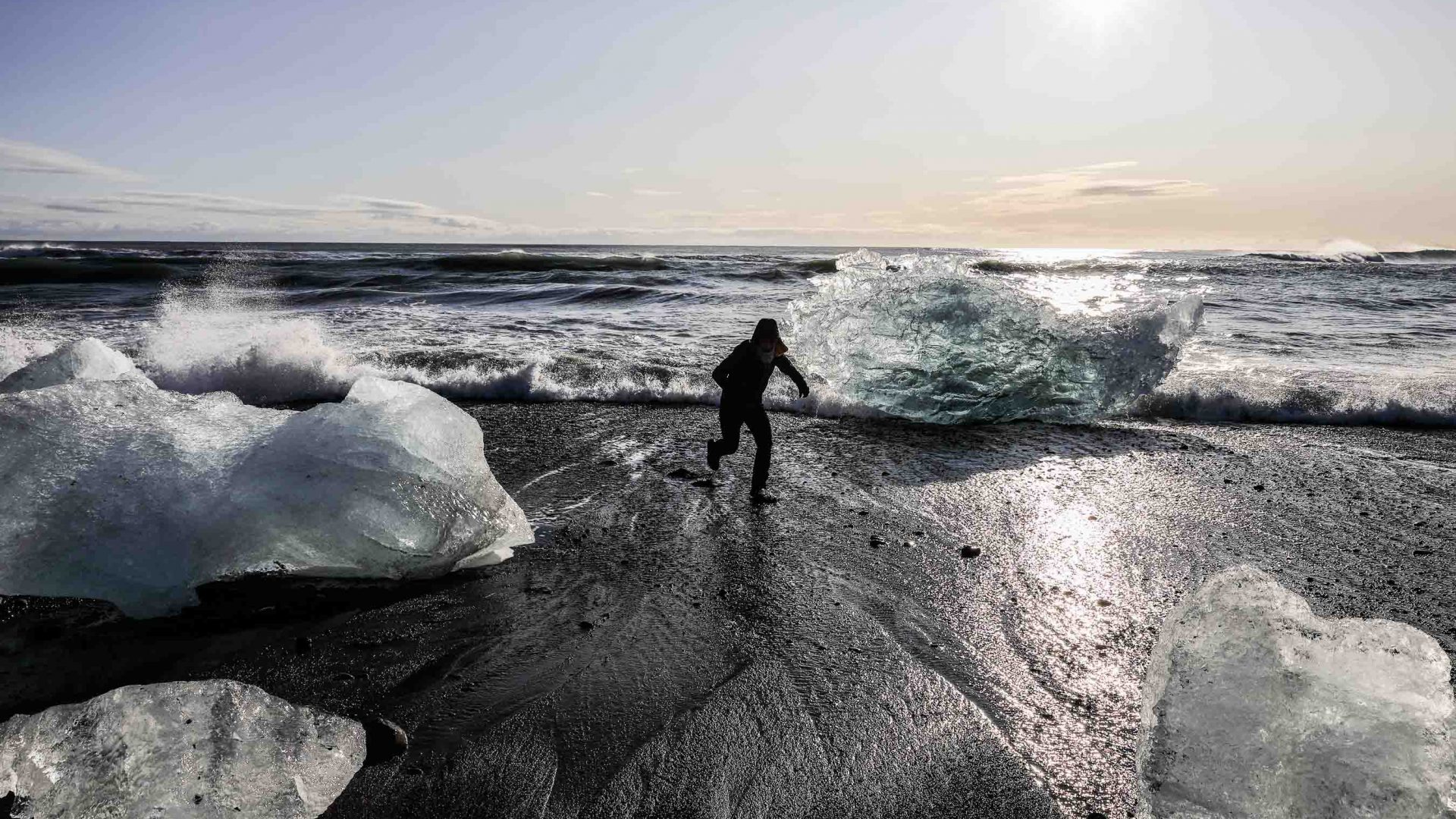 The silhouette of a person walks, surrounded by ice.