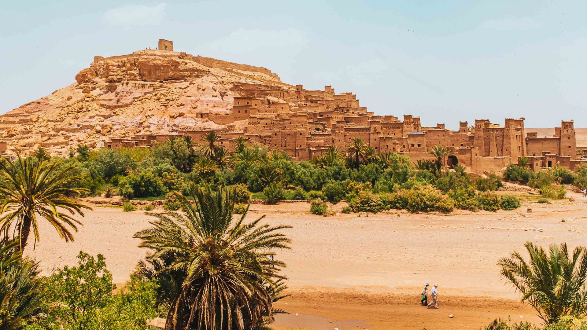Ait Benhaddou surrounded by green vegetation.