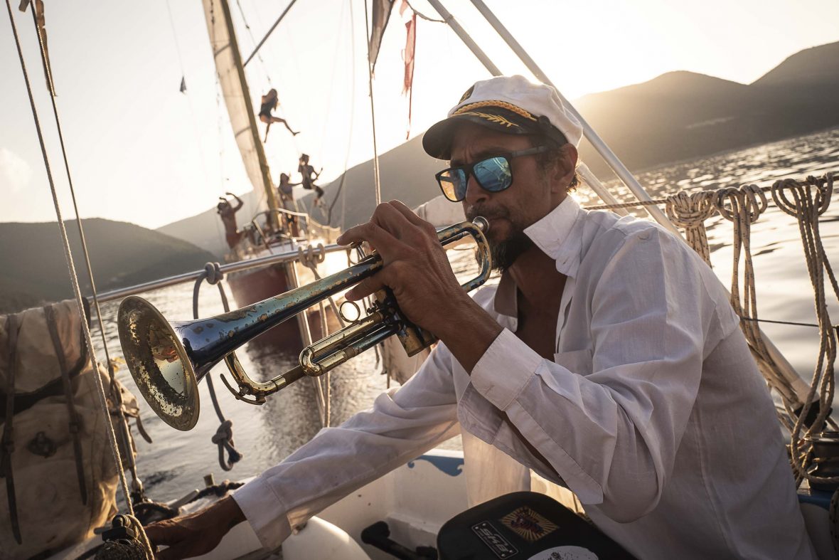 Alcaro plays the trumpet on the boat.