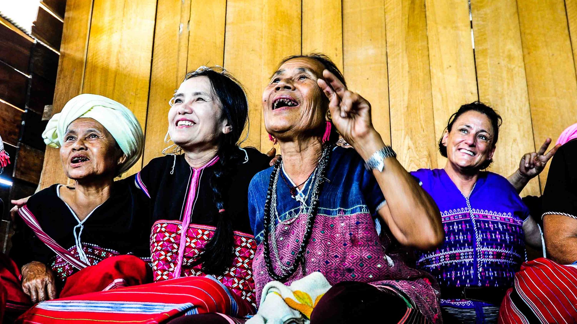 Om Koi Karen women with Lek Chailert. they are all smiling and looking up.