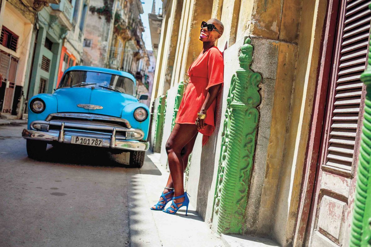 A woman standing on a street in Cuba,