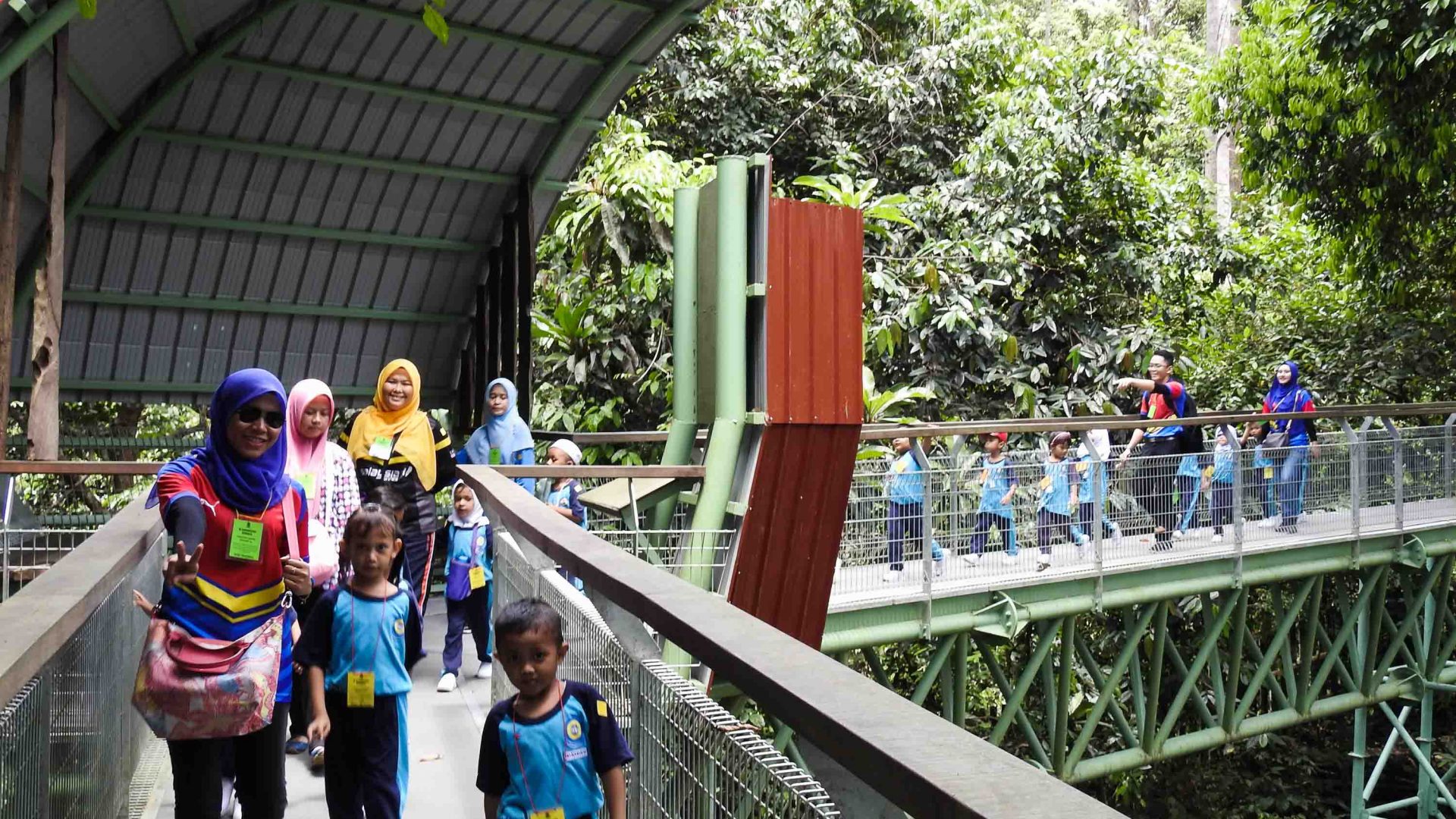 An aerial walkway with tourists on it at the Bornean Sun Bear Conservation Centre.