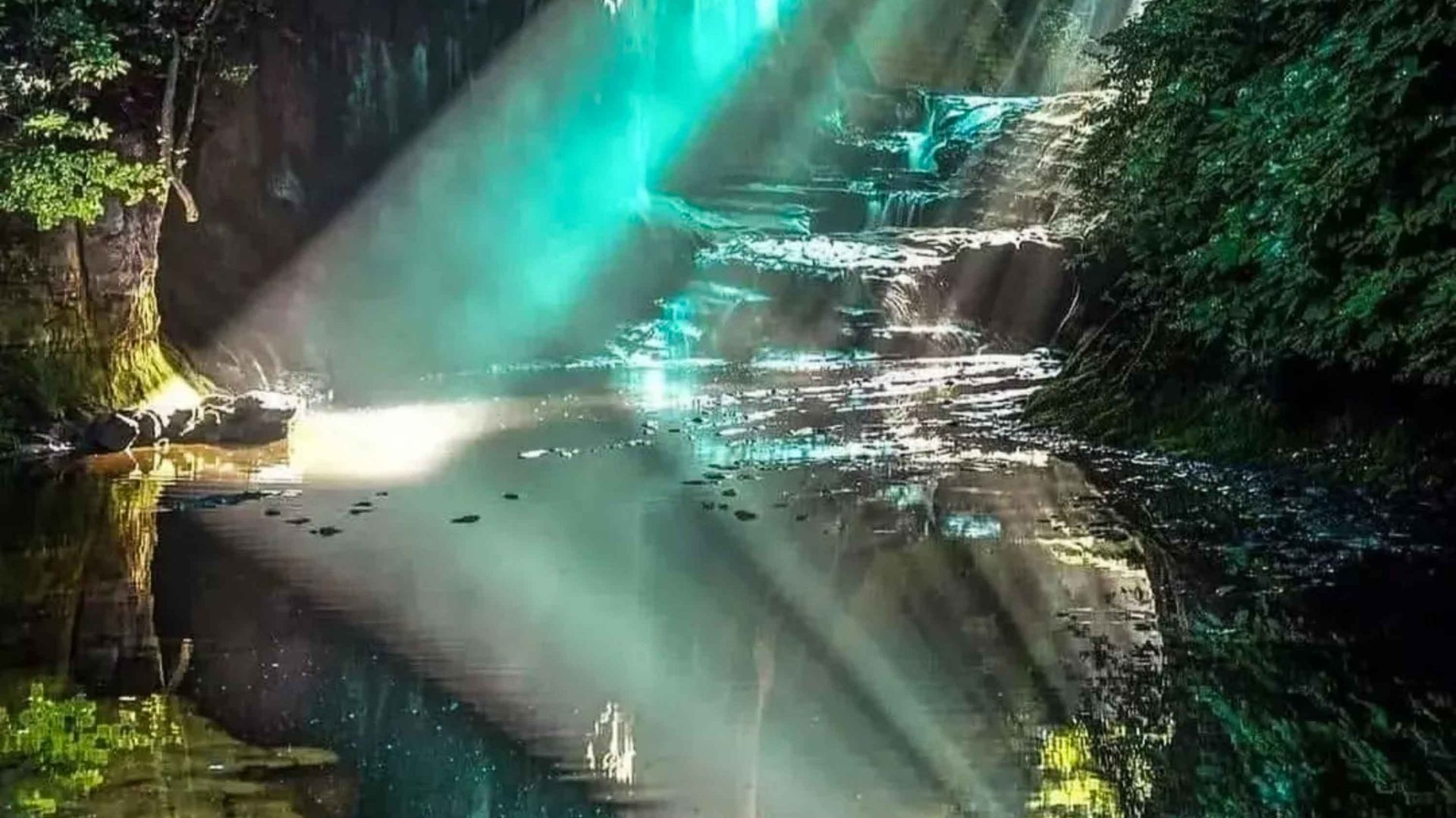A shaft of light hits a pool of water.