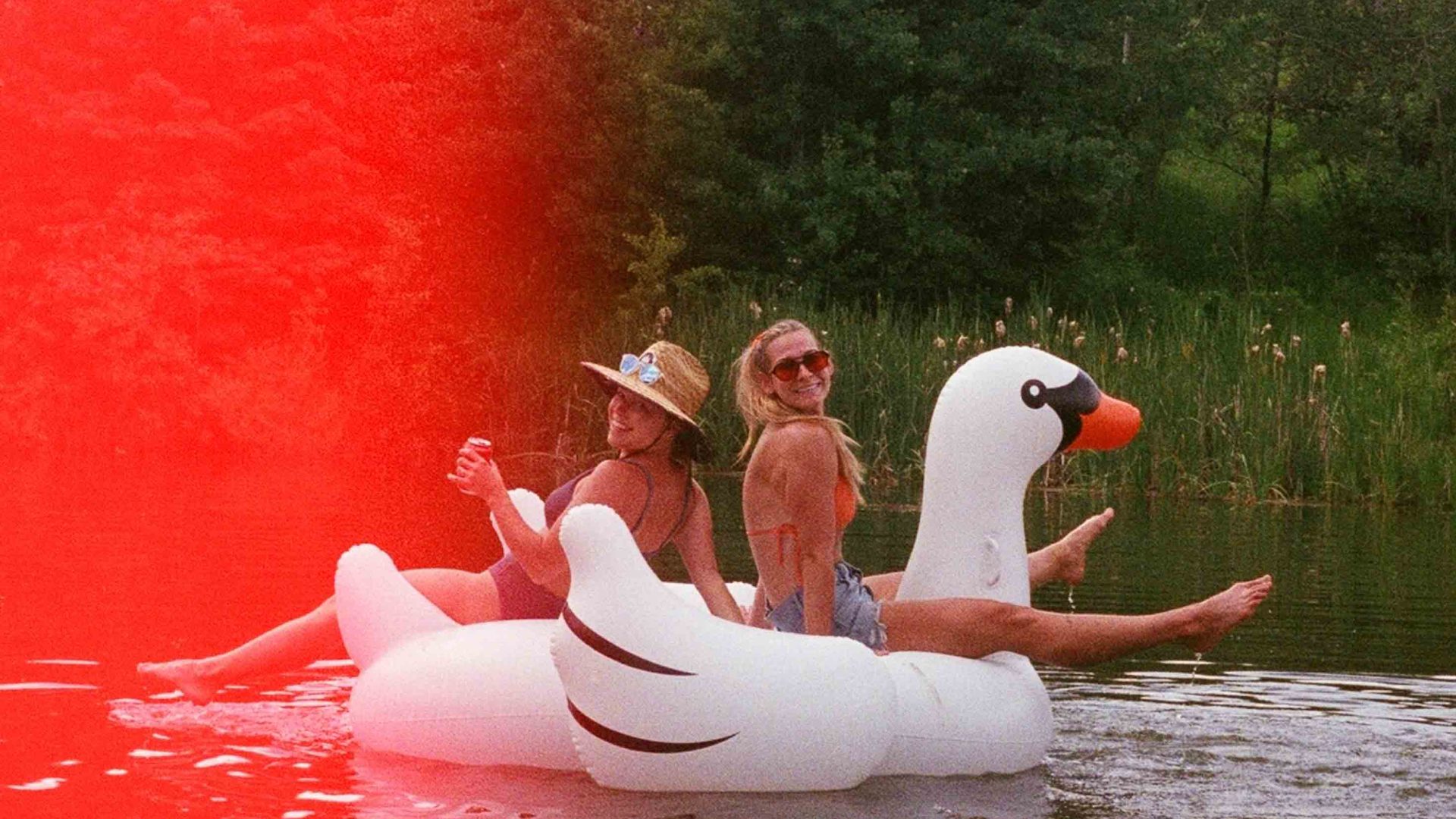 Writer Lauren Steele and a friend float around on a blow up swan.