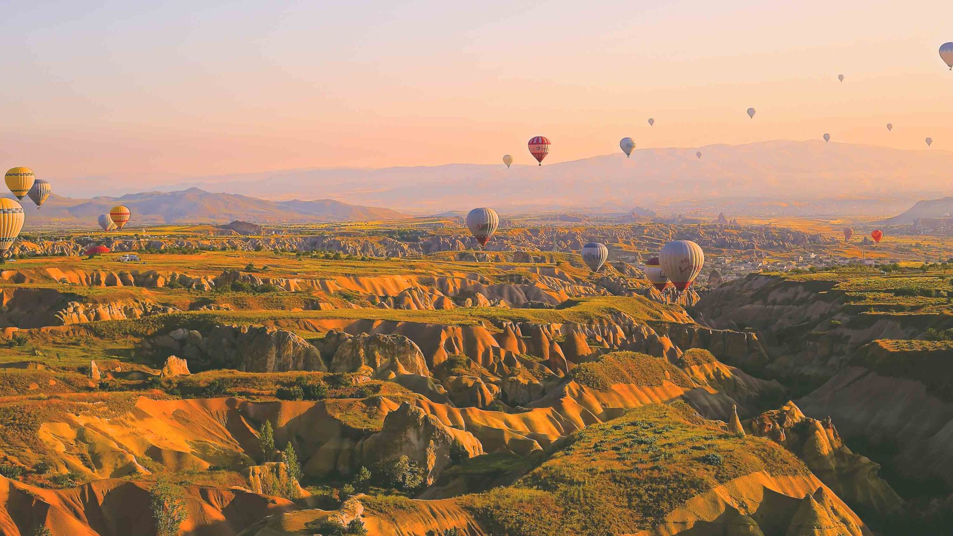 Hot air balloons above rock formations.