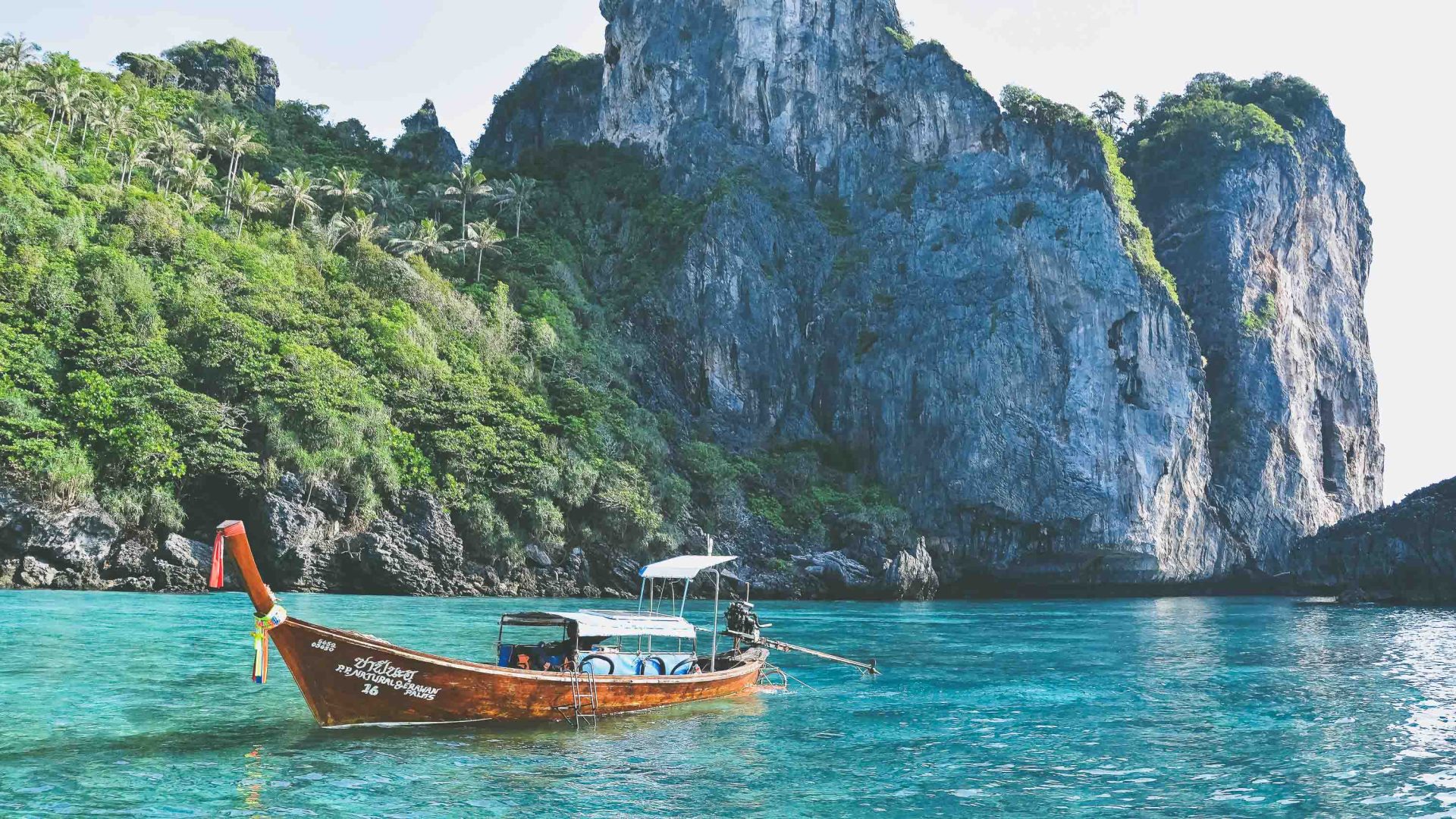 A boat in turquoise water.