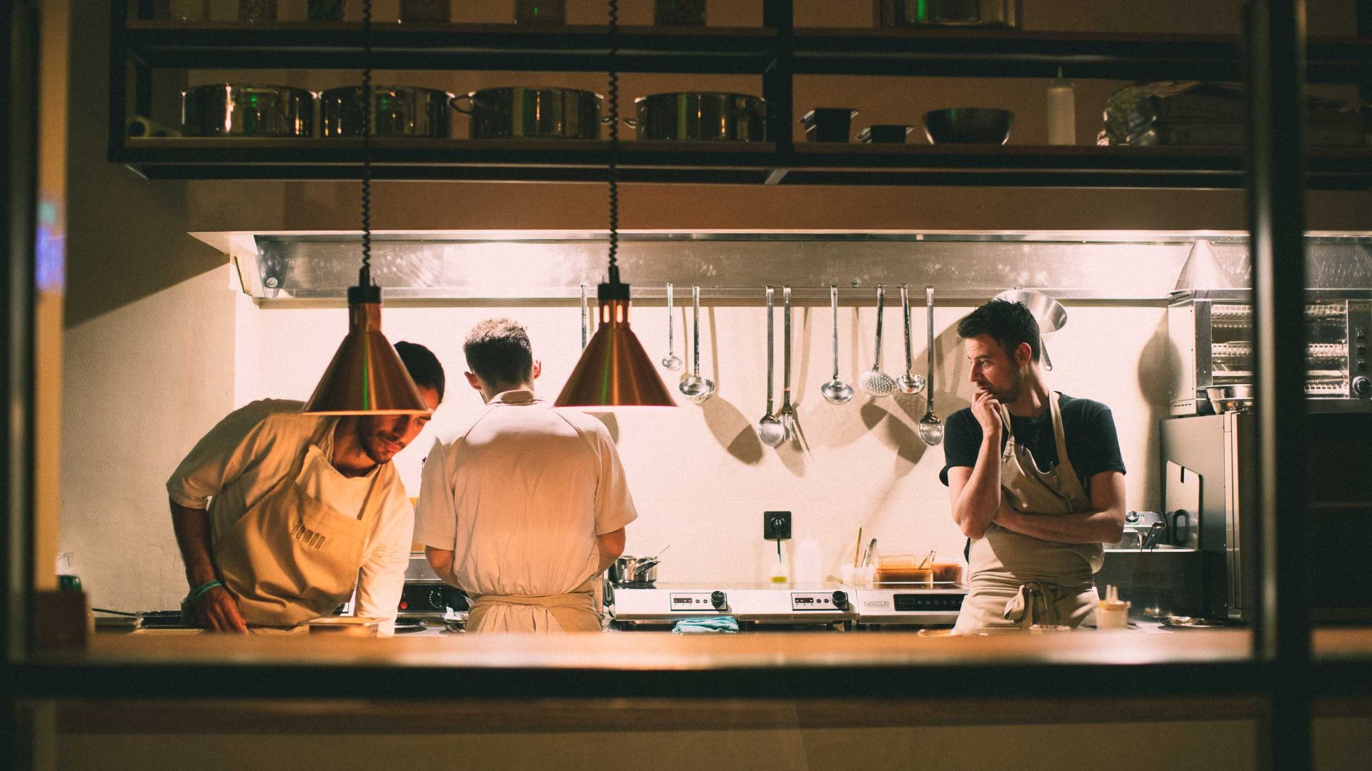 Men work in a modern kitchen.