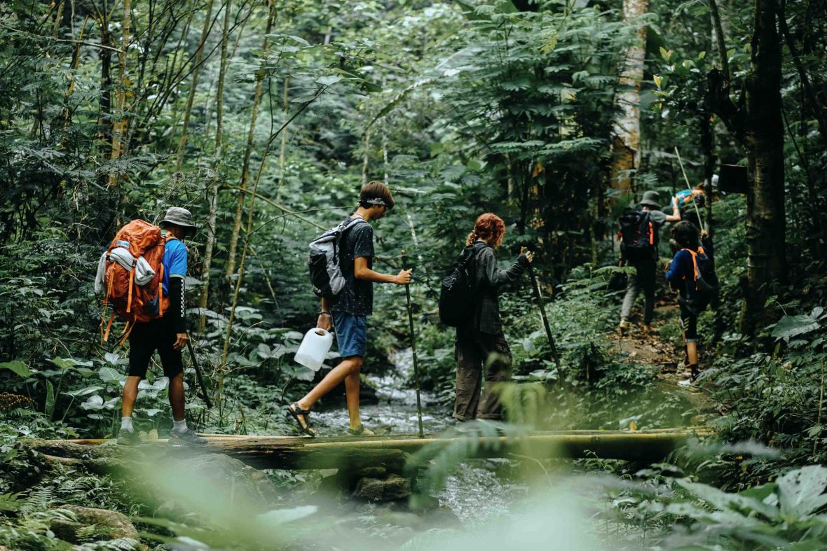 Tourists walk through dense forest on the Astungkara Way.