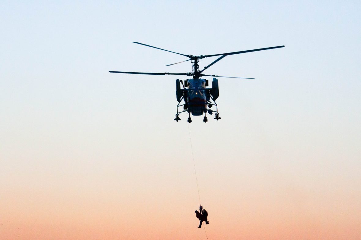 A helicopter rescue at sunset.