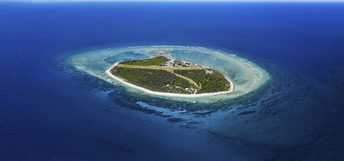 An aerial view of the island, surrounded by blue water.