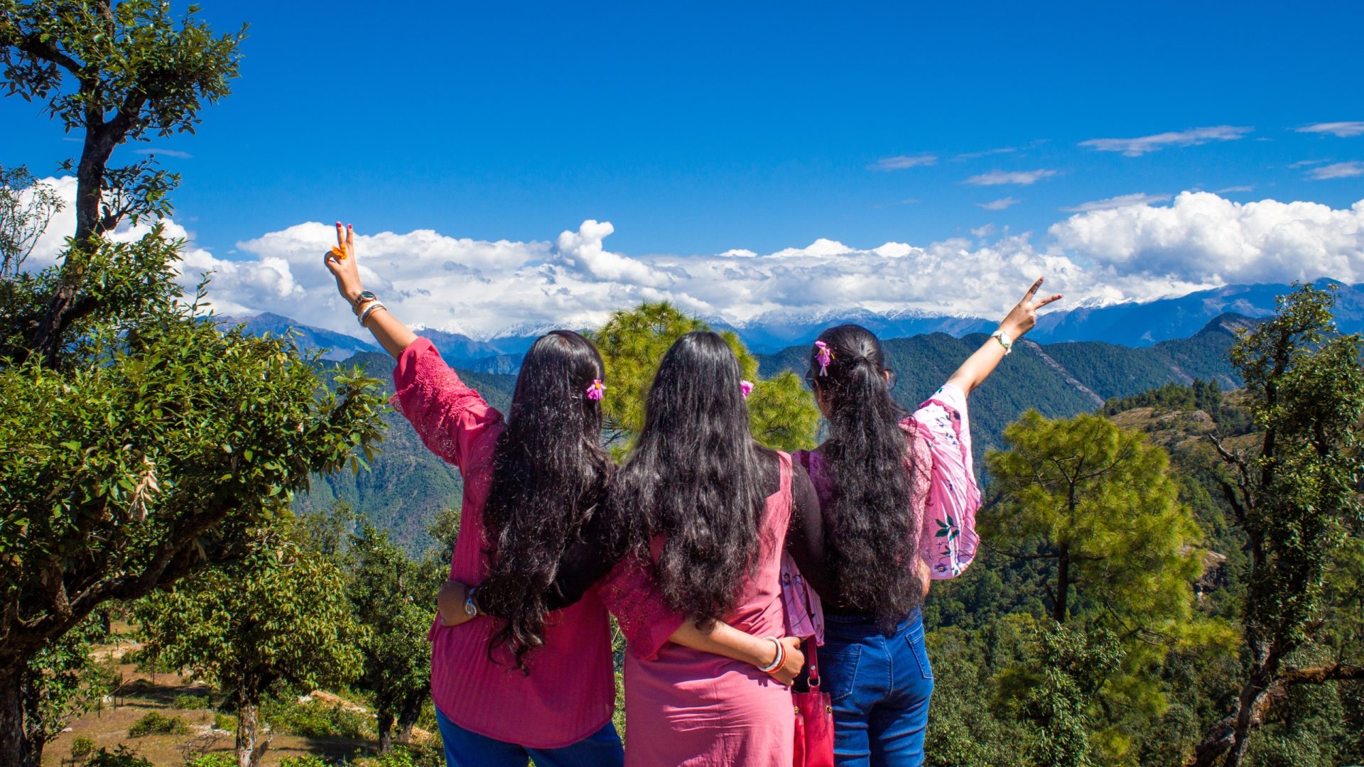 Three women looking over a panoramic view