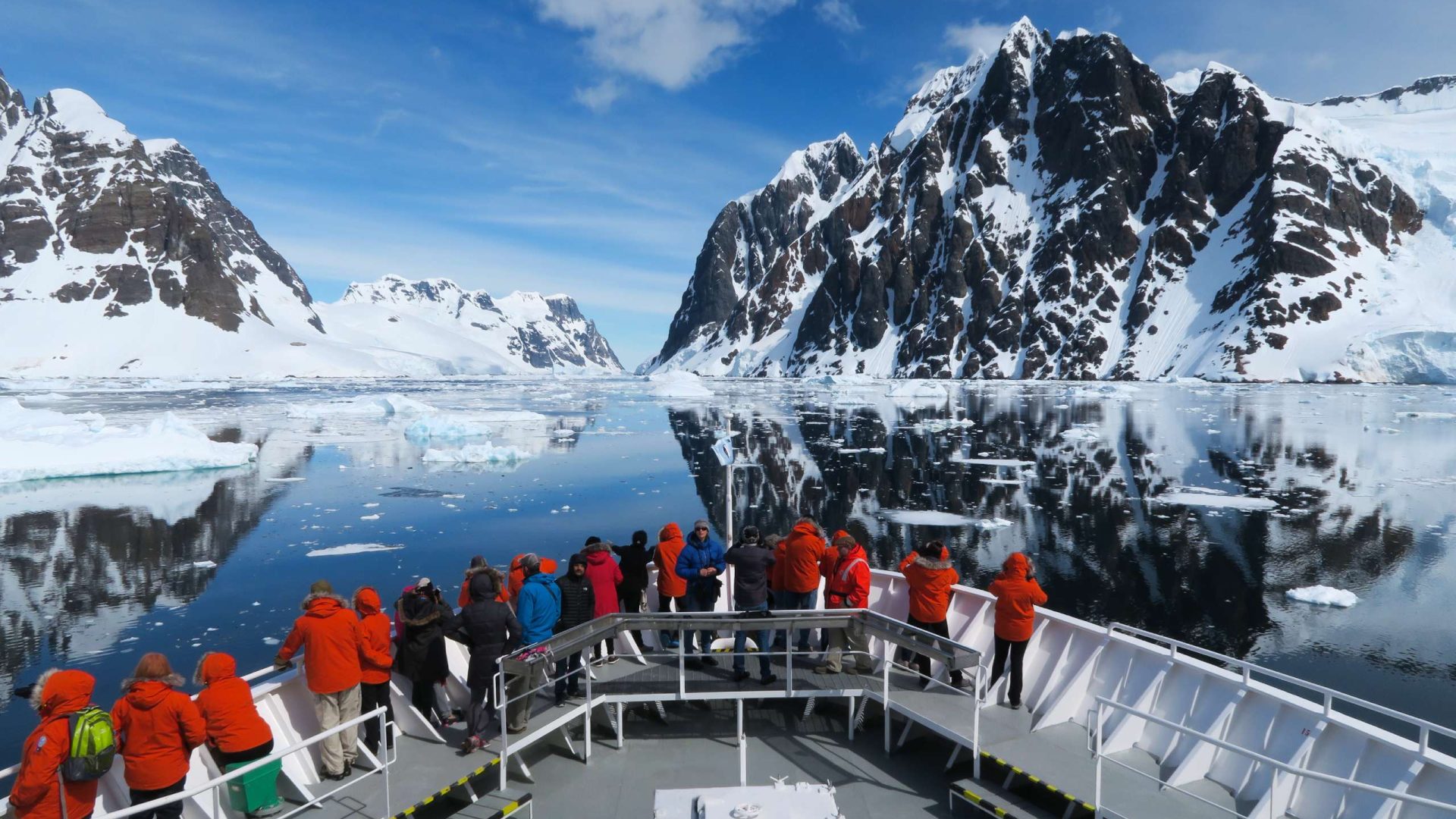 Passengers at the front of an Antarctica cruise ship.