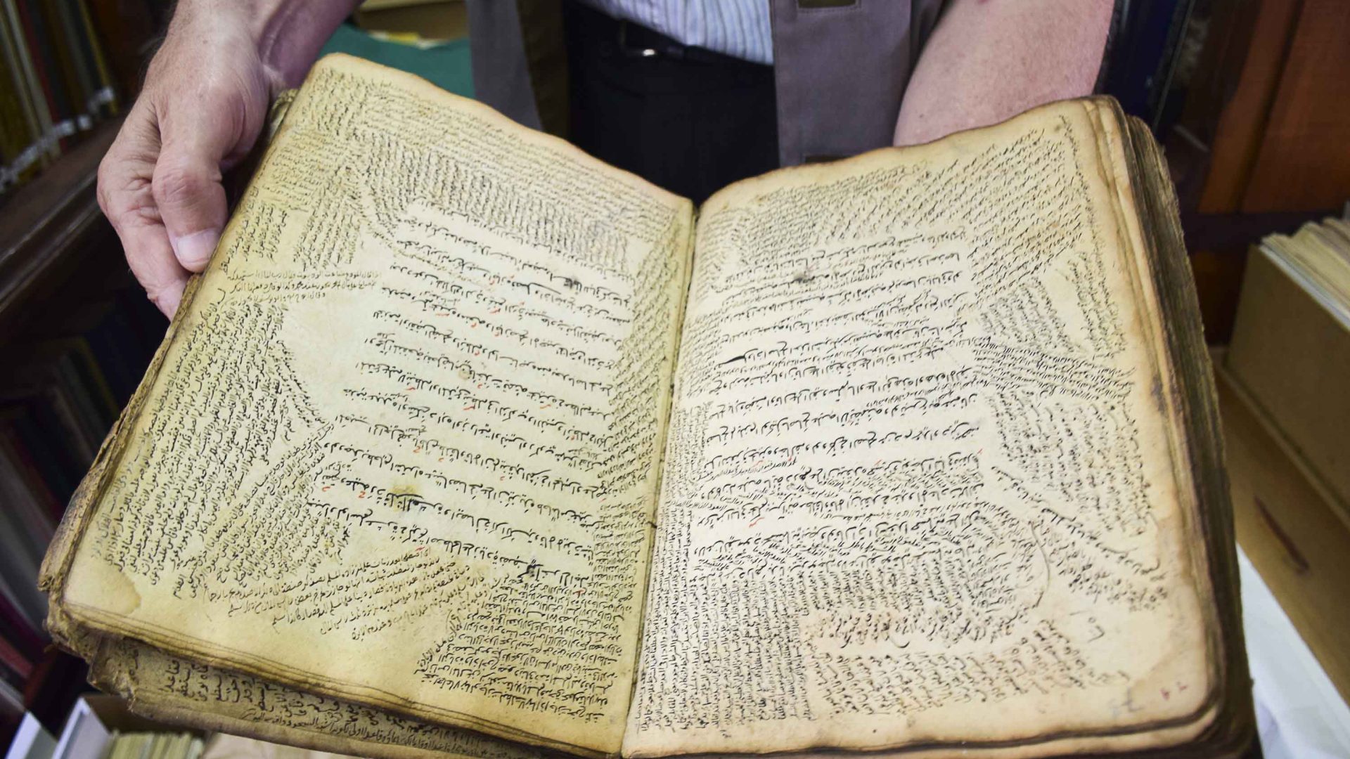Close-up of ancient book of Islamic jurisprudence in library.
