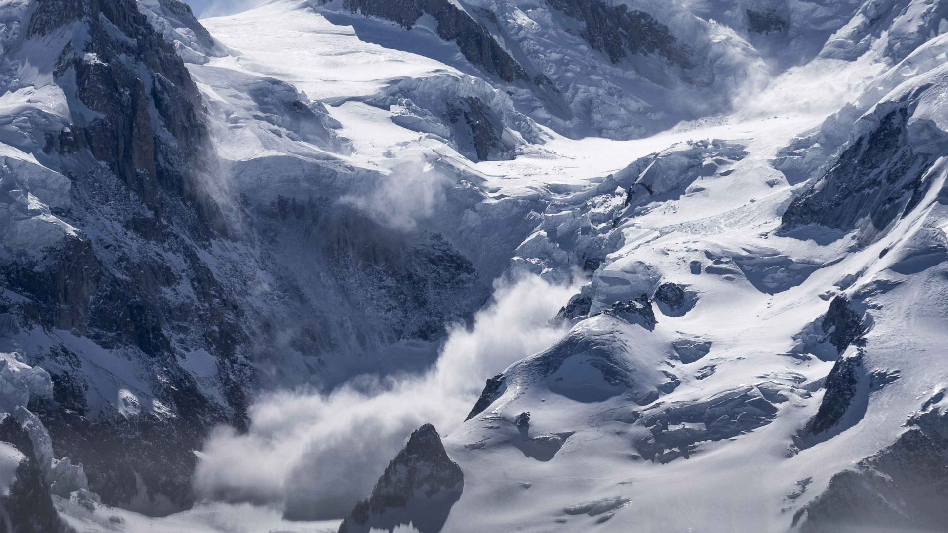 An avalanche on a snowy mountain.