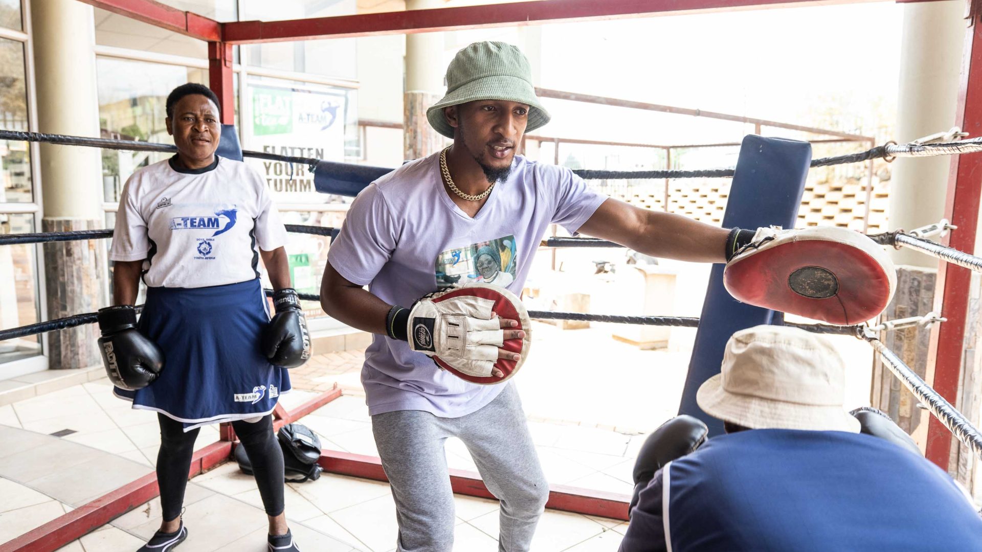Coach Mthunzi Tyler Maphosa in the ring with some boxing grannies.
