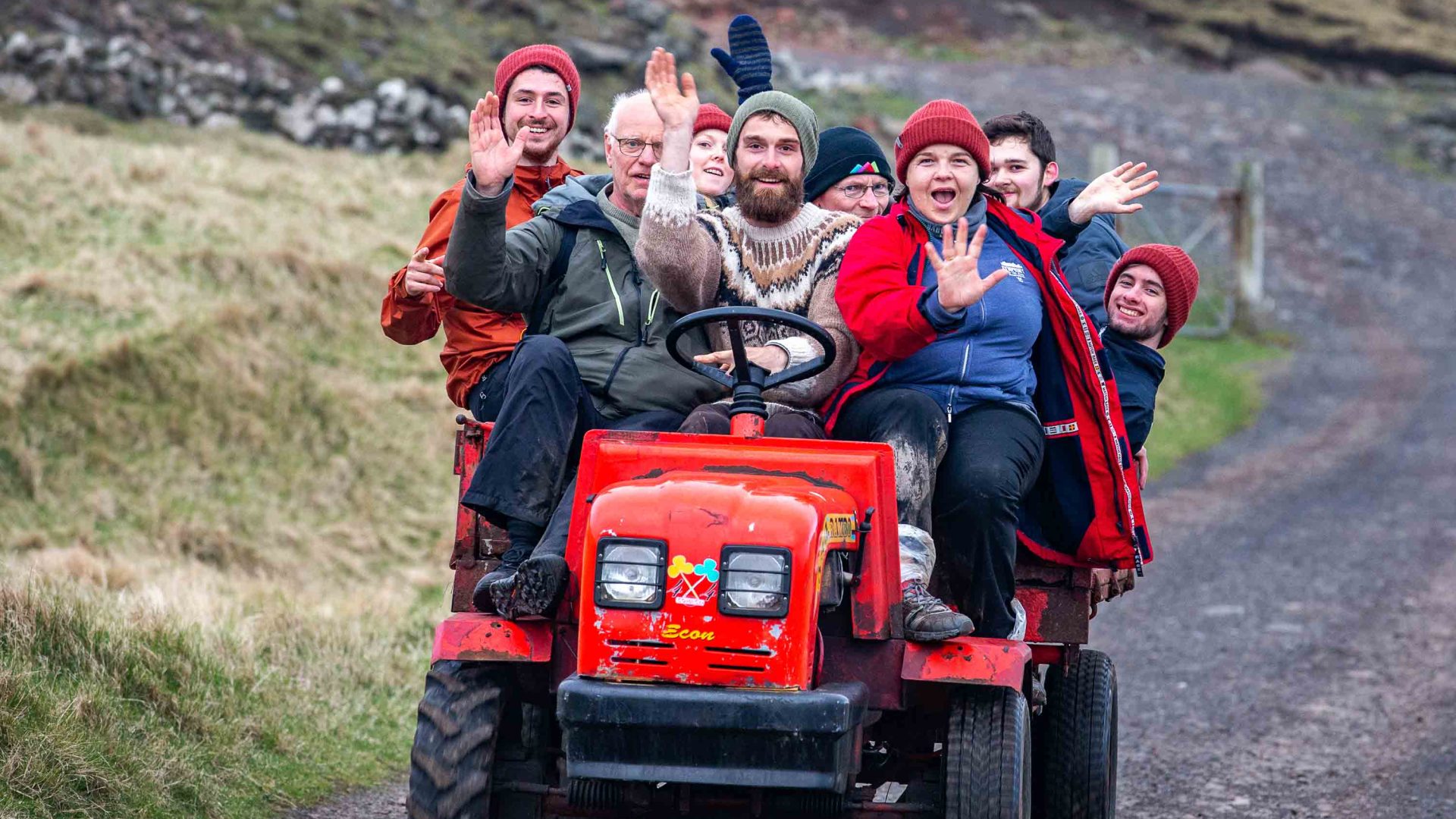 A group of happy volunteers on a small quad bike.