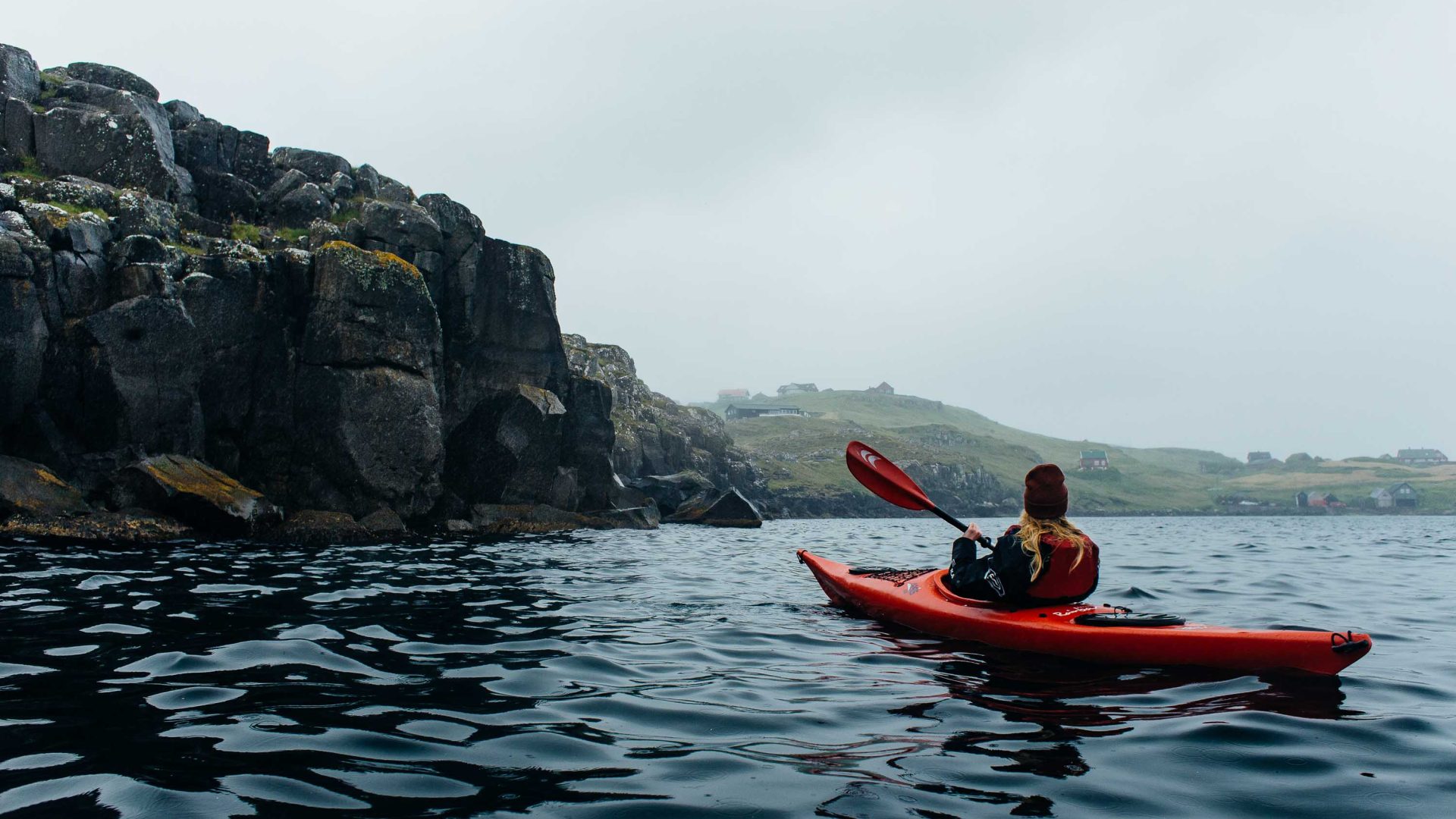 A single person kayaking in the Faroe Islands..