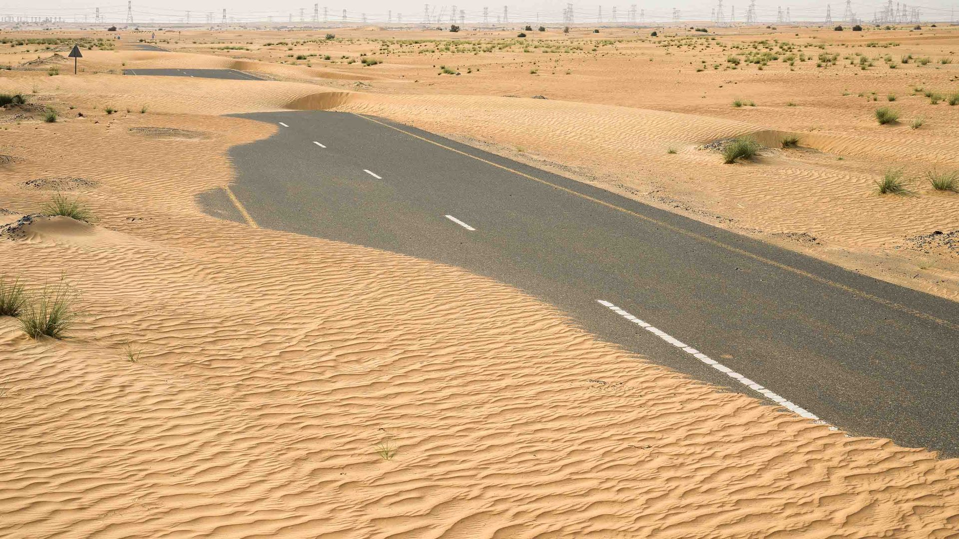 A road winds through the desert.