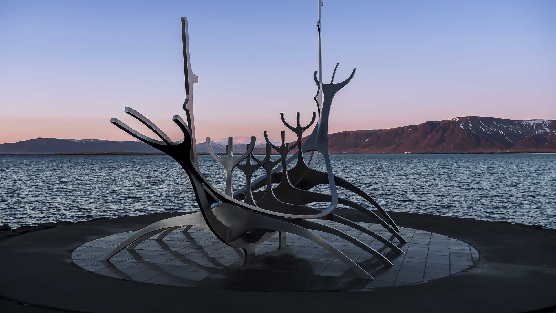 A viking ship sculpture seen in low light.