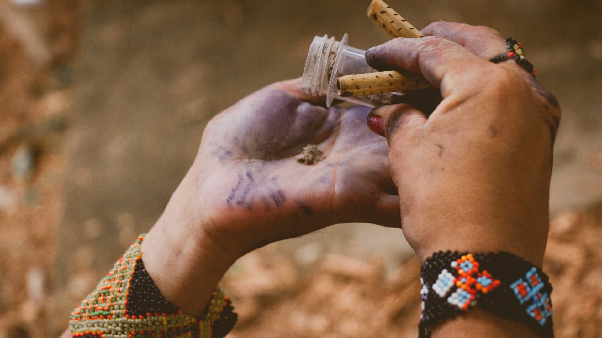 A persons tips out some traditional medicine into their hands.