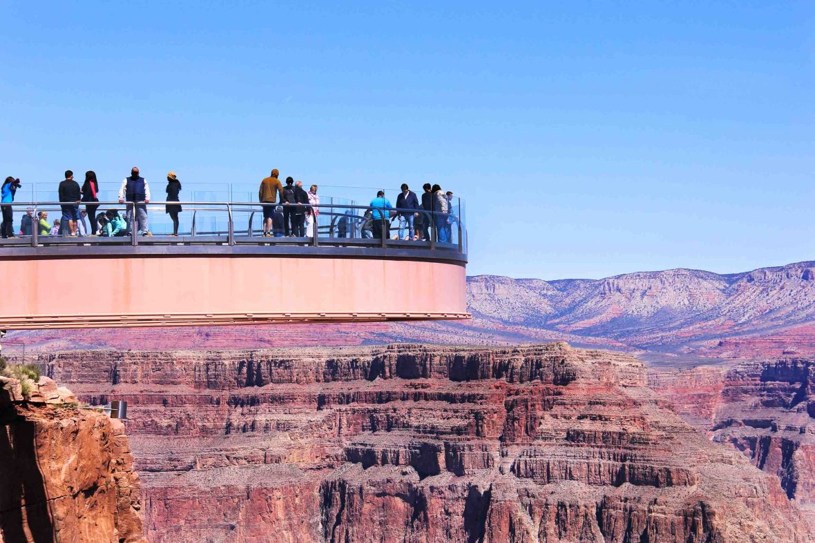 Tourists look out at the view at the Grand Canyon.