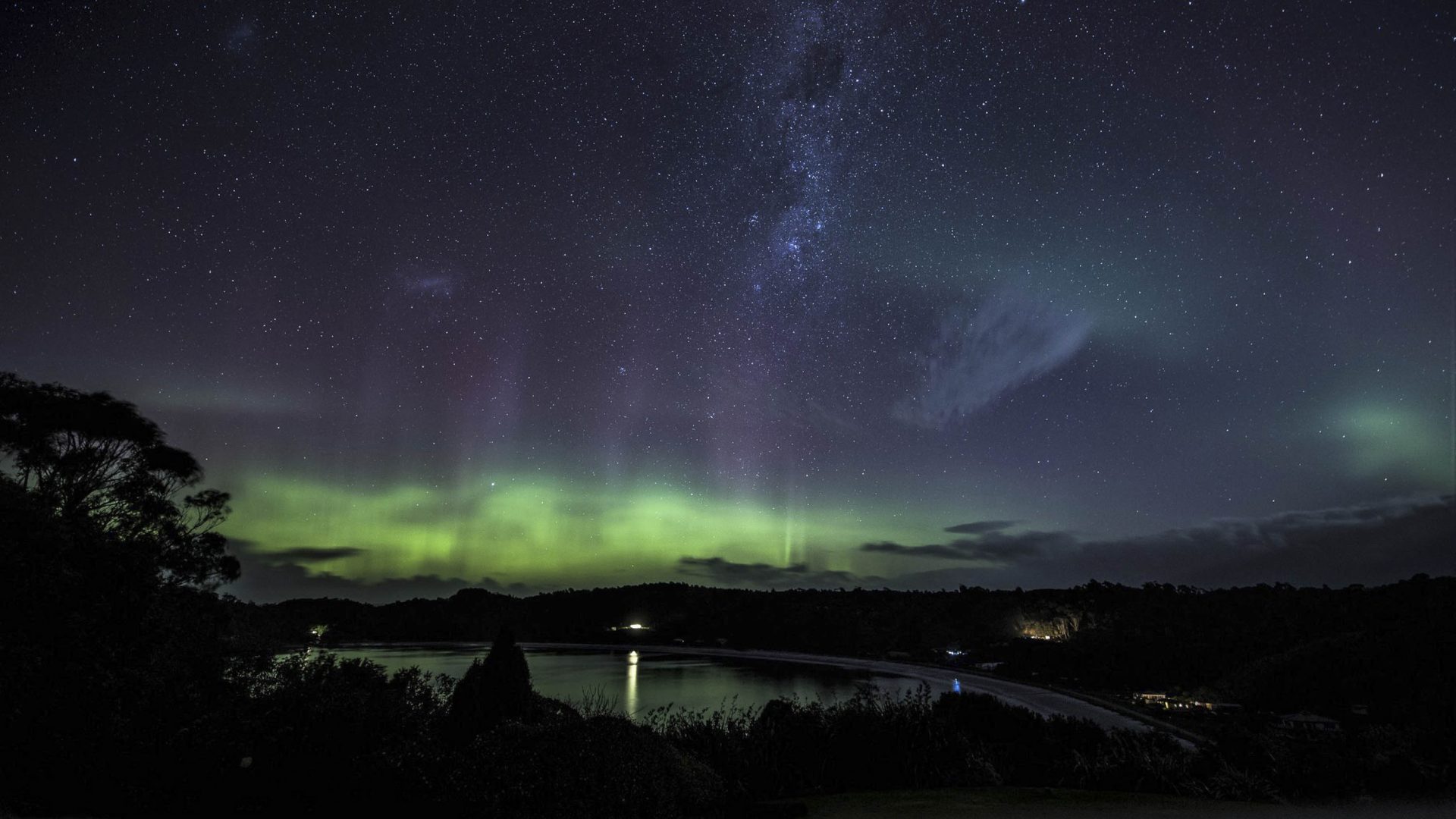 Aurora borealis in the sky above Rakiura makes the night sky green.