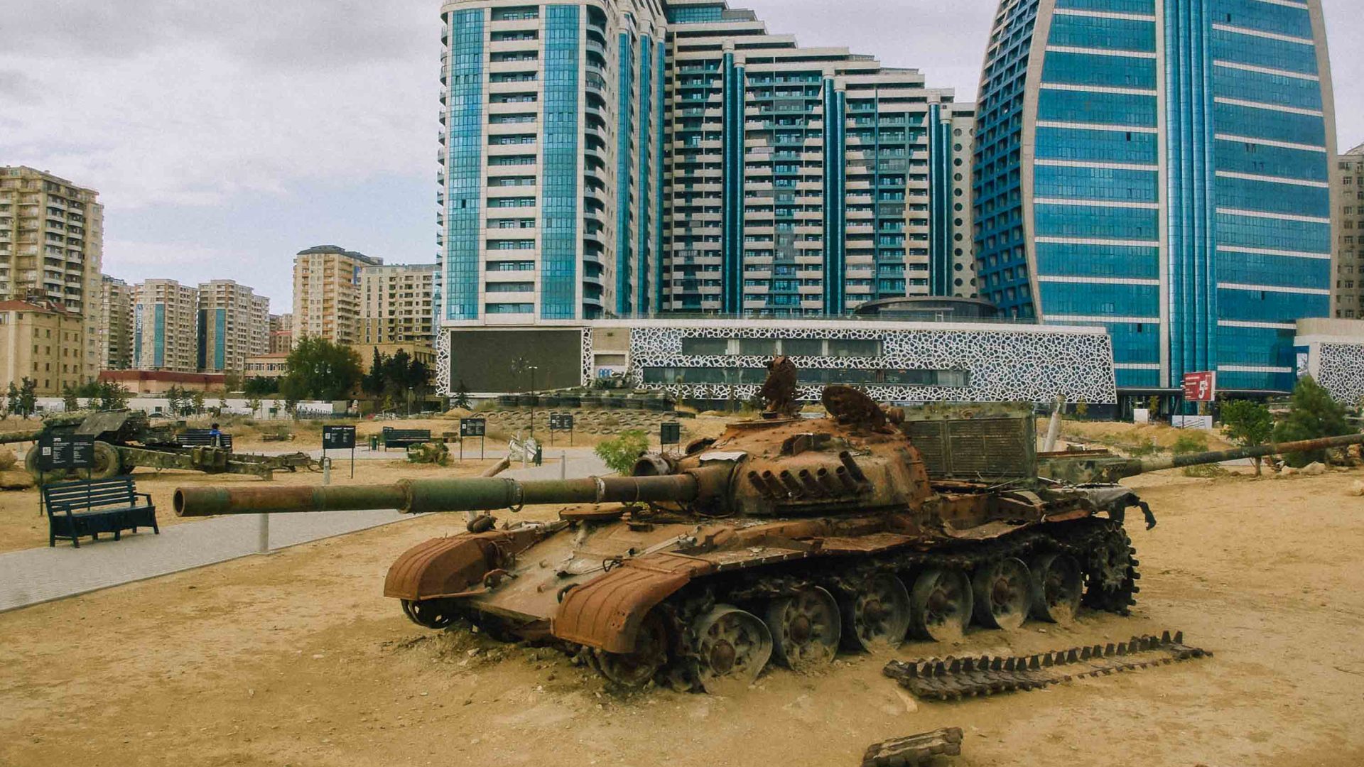 An ex tank in the foreground and the city in the background.