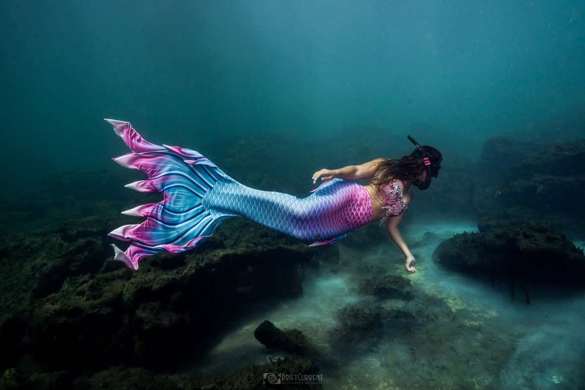 The writer swims as a mermaid underwater.