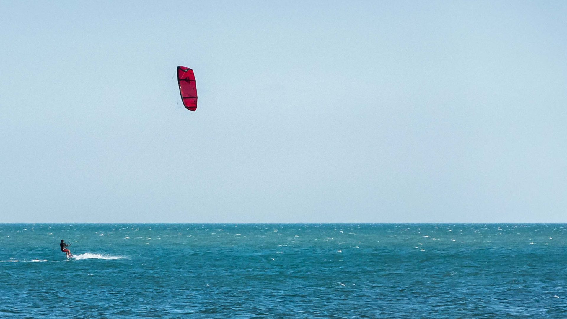 A tourist kite surfing.