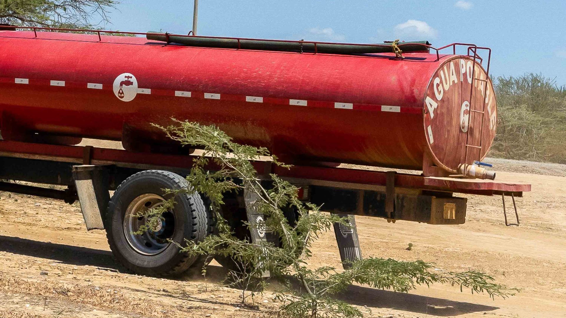 A red water tanker used to deliver potable water.