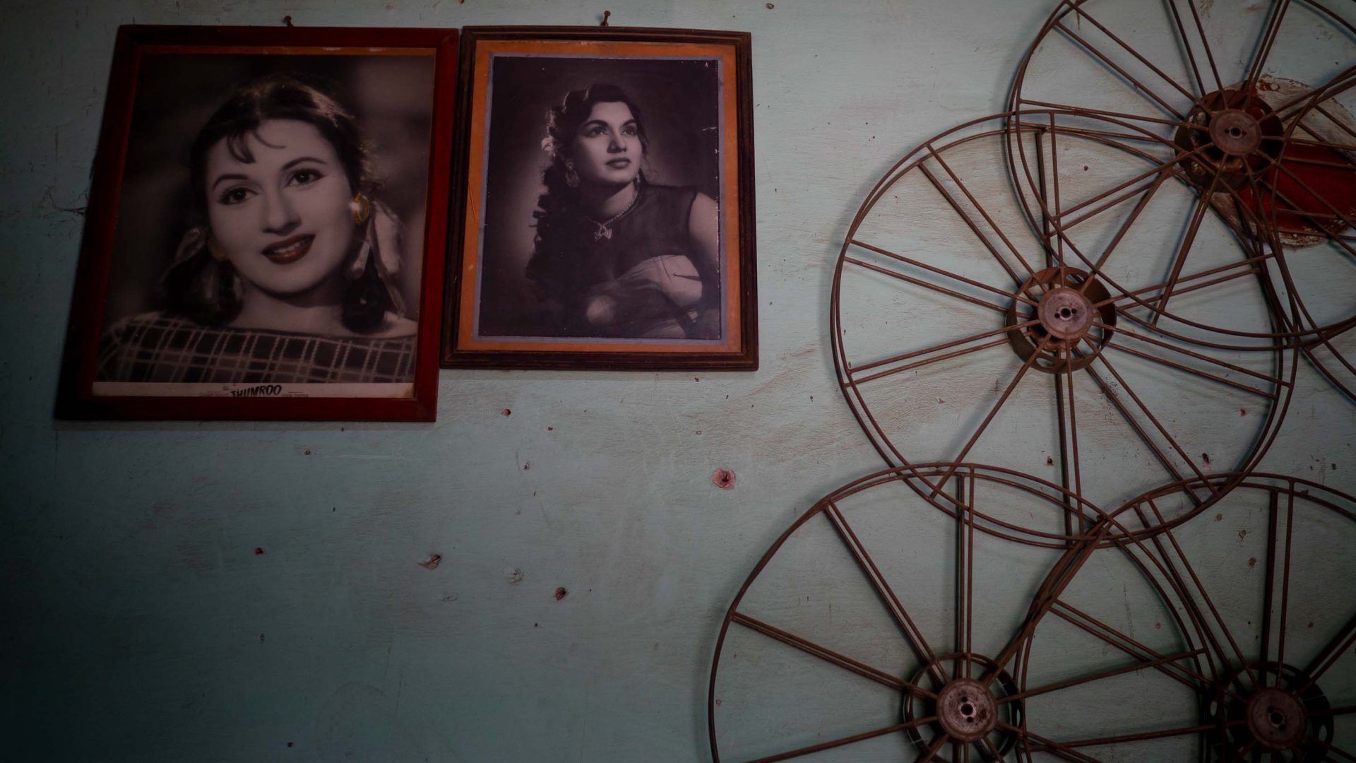 Photos of female film stars are on the wall alongside film reels.