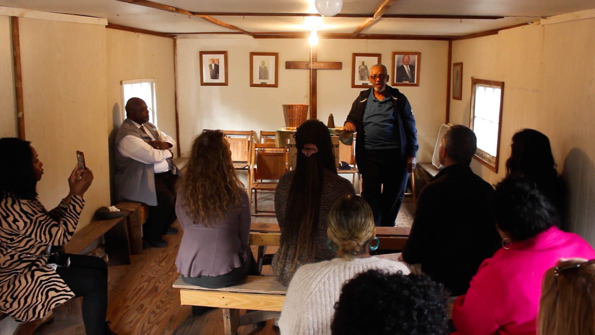 The group at a Praise House, being spoken to by the Reverend.
