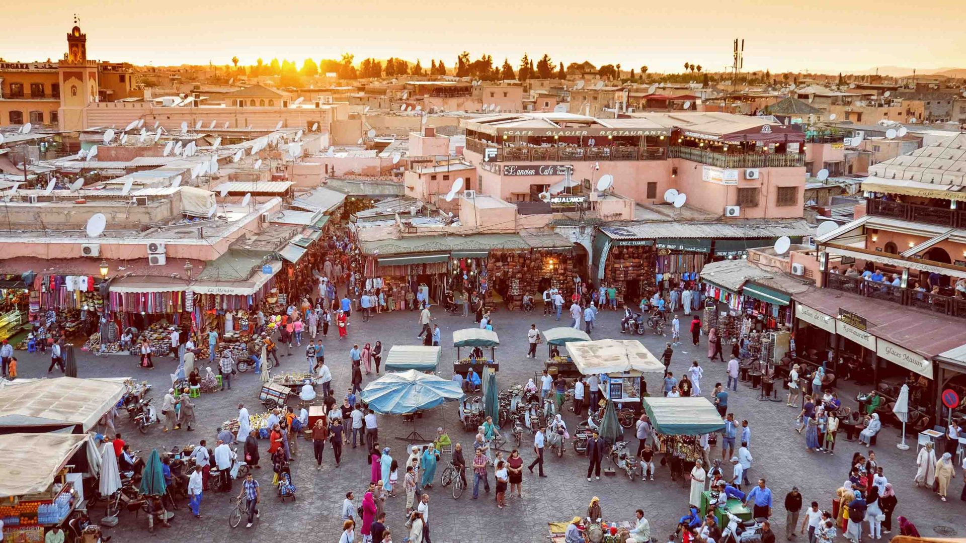 Jemma El Fna - a market in Marrakesh - seen at the end of the day with the sun setting over the stalls.