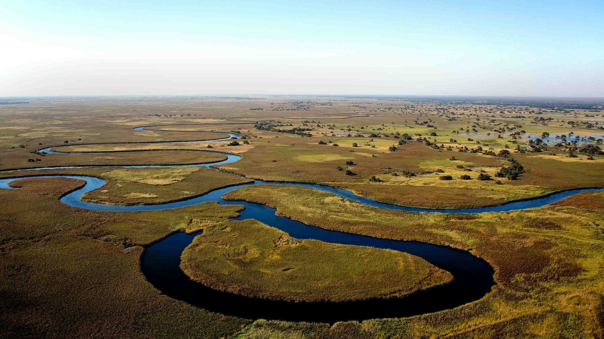 An aerial view of a river running through flat plains.