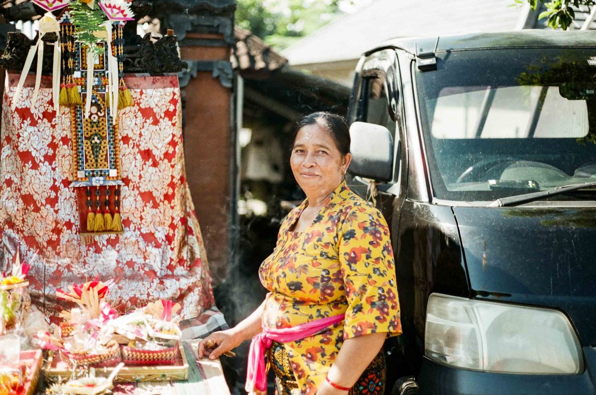 A street vendor smiles to camera.