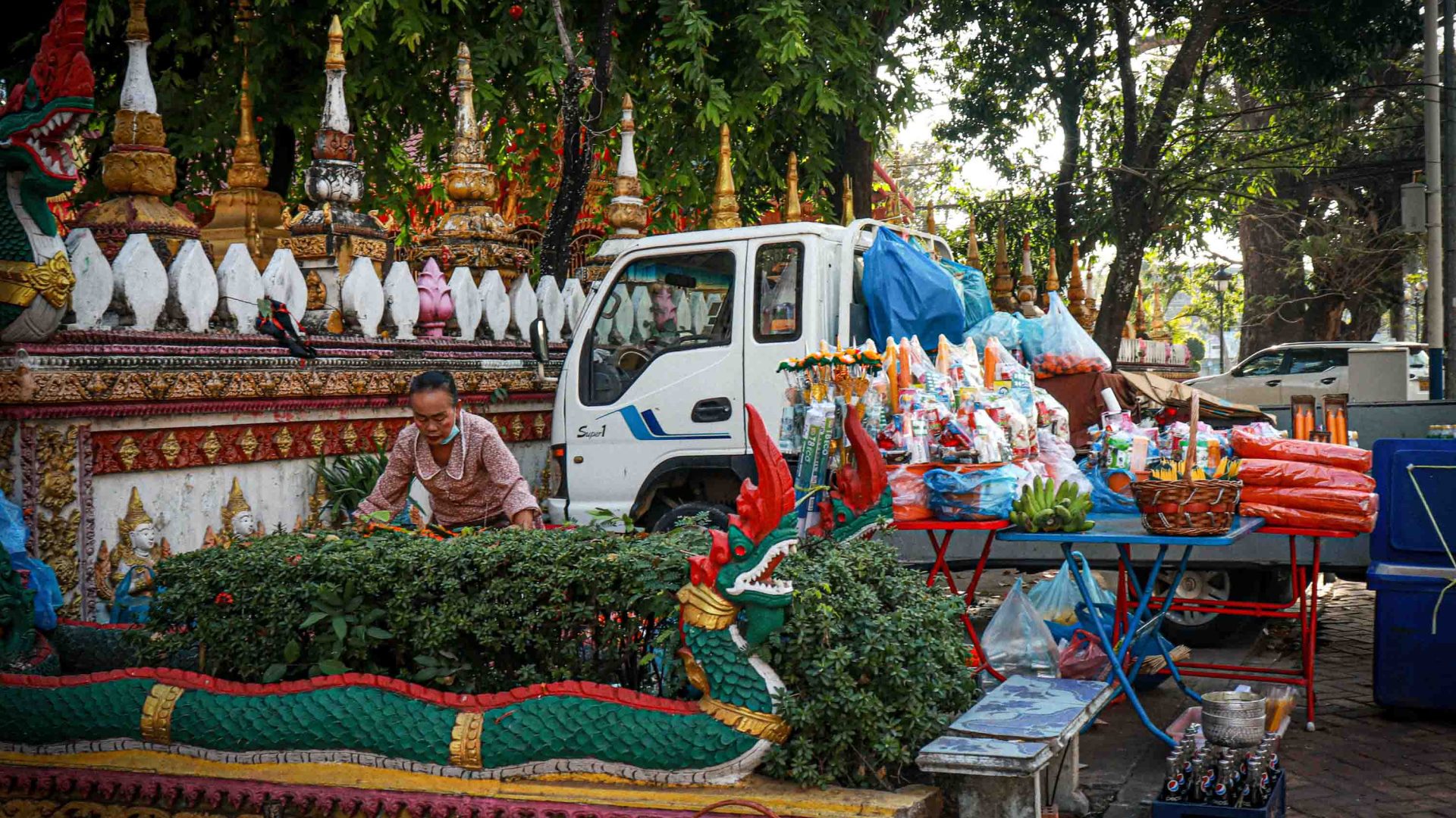A woman sells flowers outside a temple in Vientiane.