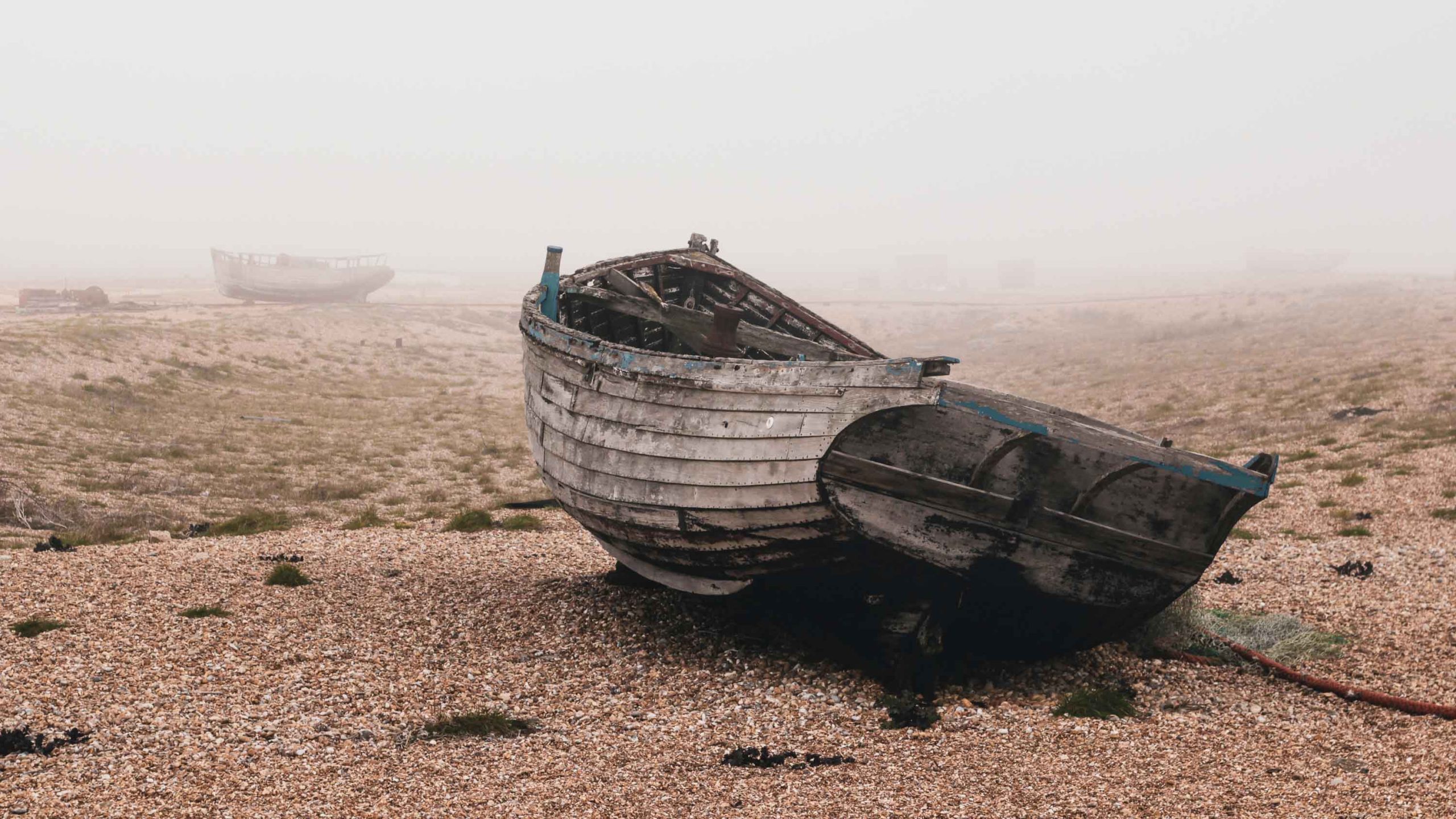 Fishing boats lined up on the beach at Dungeness, Kent, UK.
