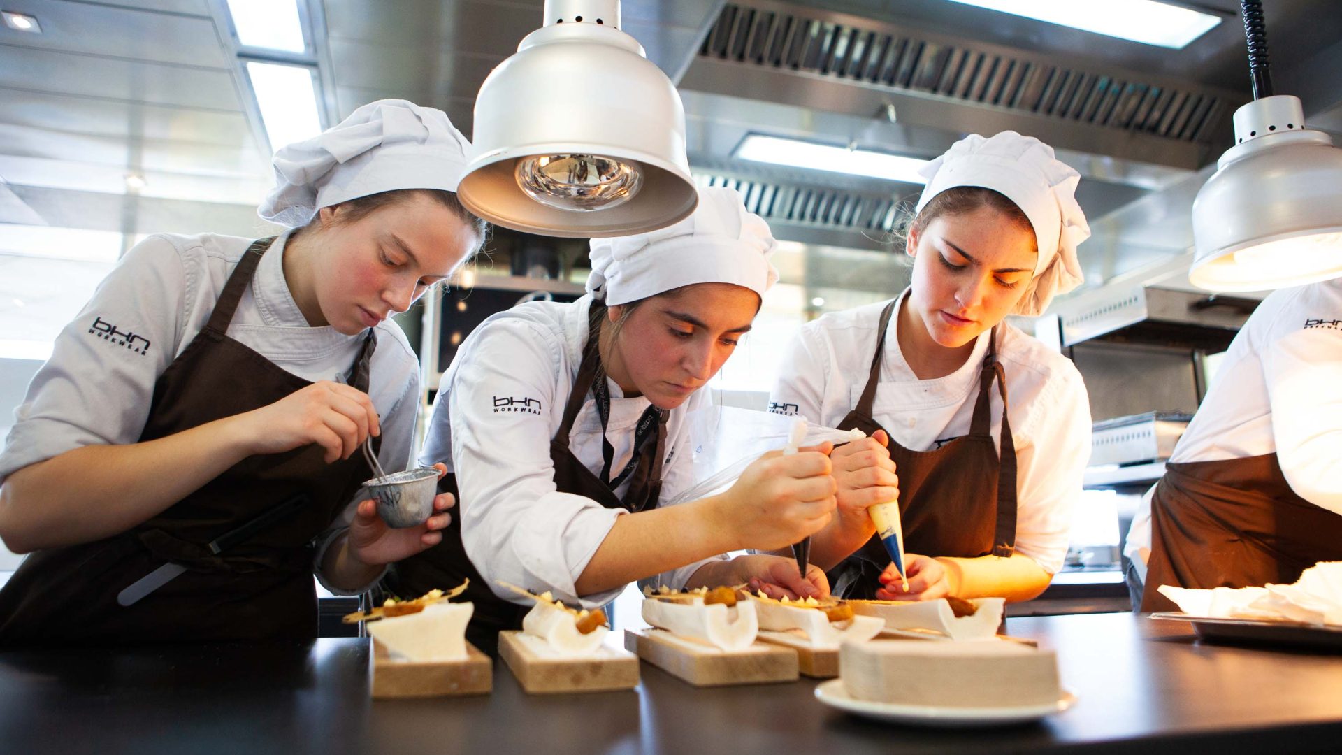 Three female chefs at work.