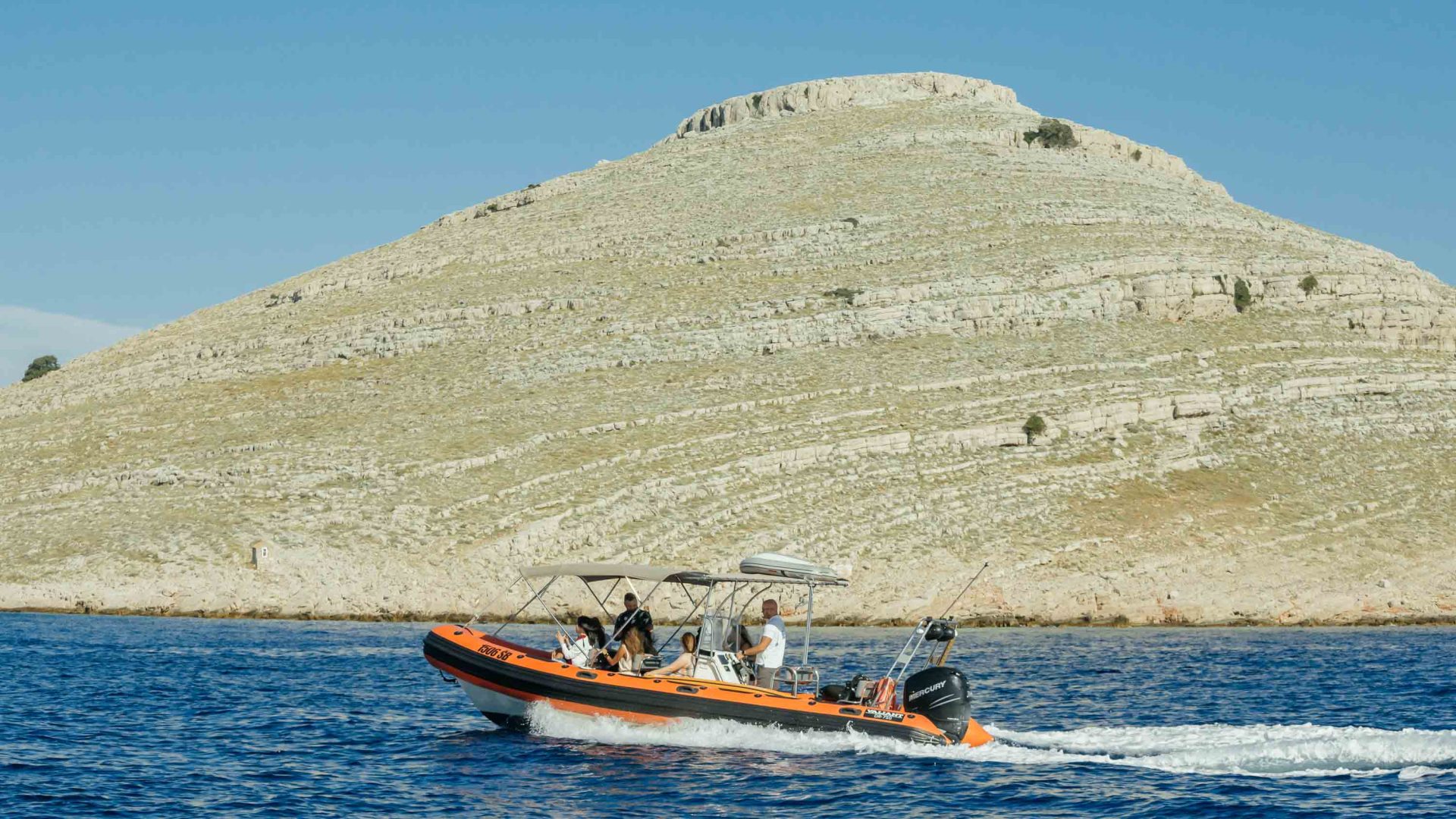 A small boat of people travels to Kornati.