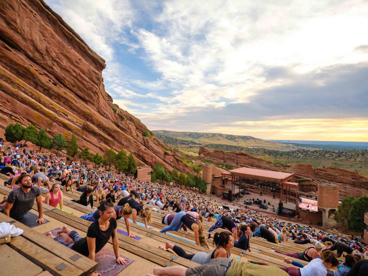 People do yoga at Red Rocks ampitheatre.