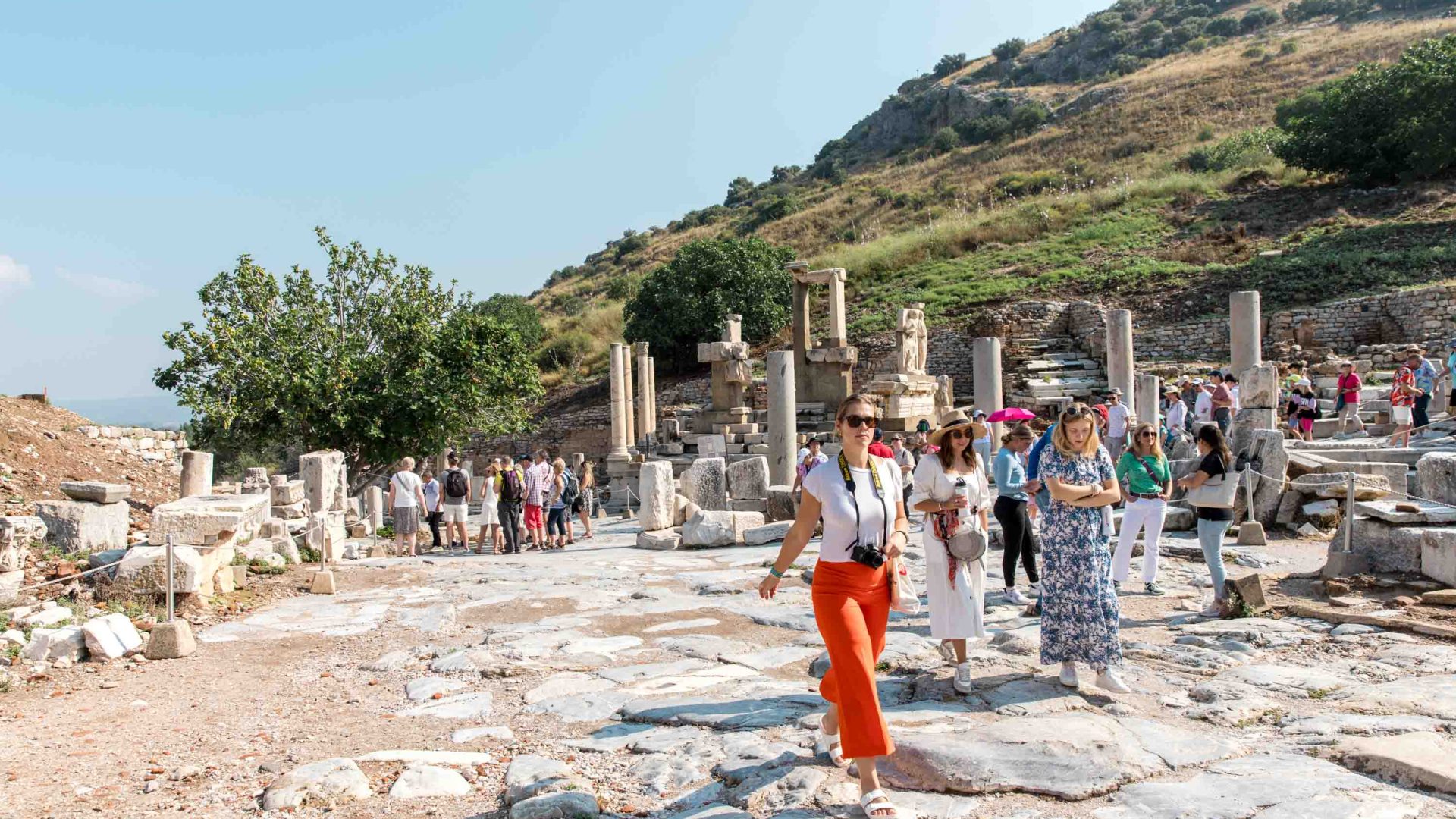 The group of travelers walks amongst the ruins of Ephesus in Selcuk.