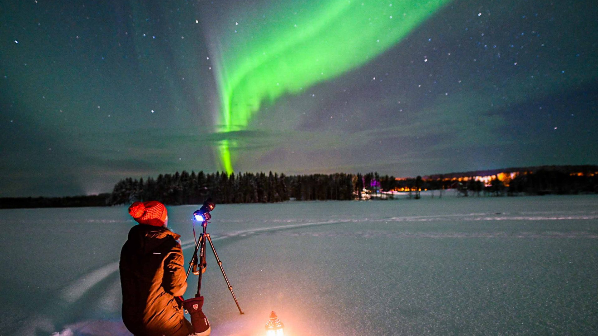 A person taking photos of the Aurora in Lapland, Finland.