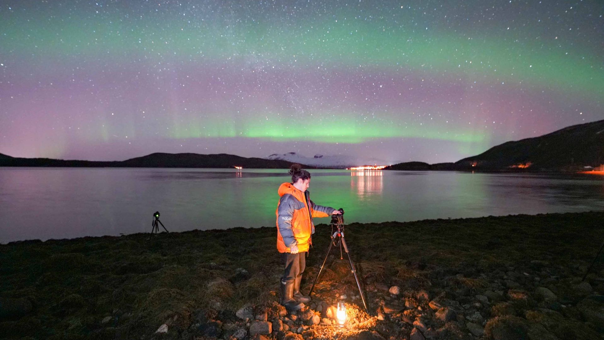 A person taking photos of the Aurora on an Arctic Road Trips journey.