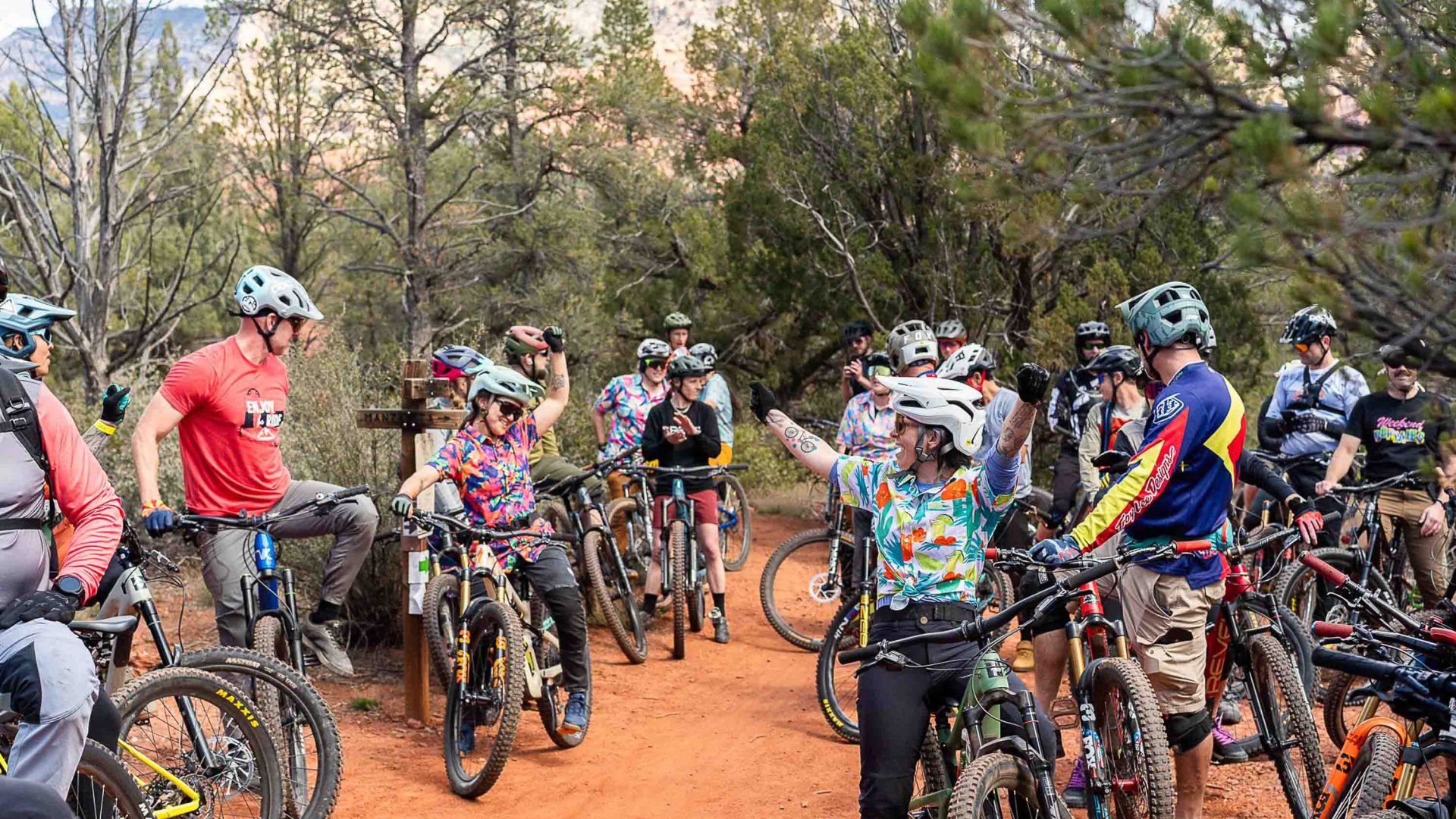 Women stand with their mountain bikes while awaiting instructions.
