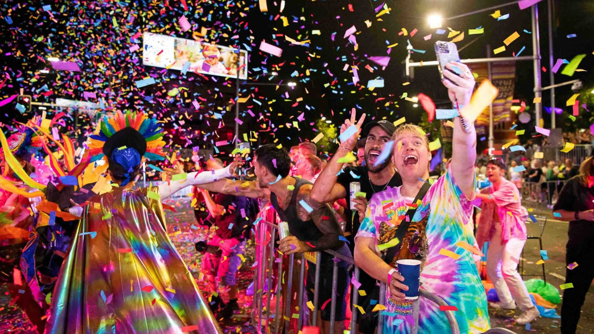 People cheer amongst confetti as the Mardi Gras Parade passes by.