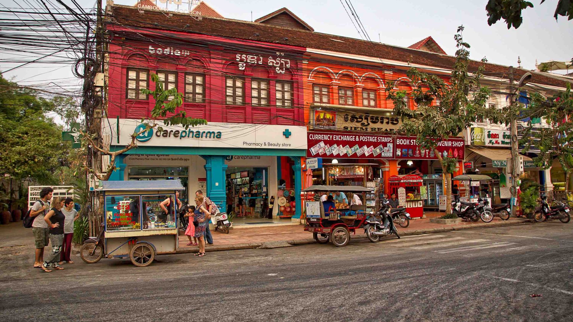 Stores and food carts on a road.