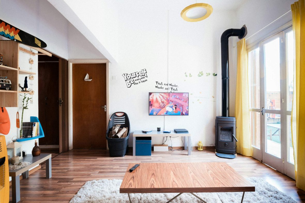 A brightly decorated lounge with wooden floors.