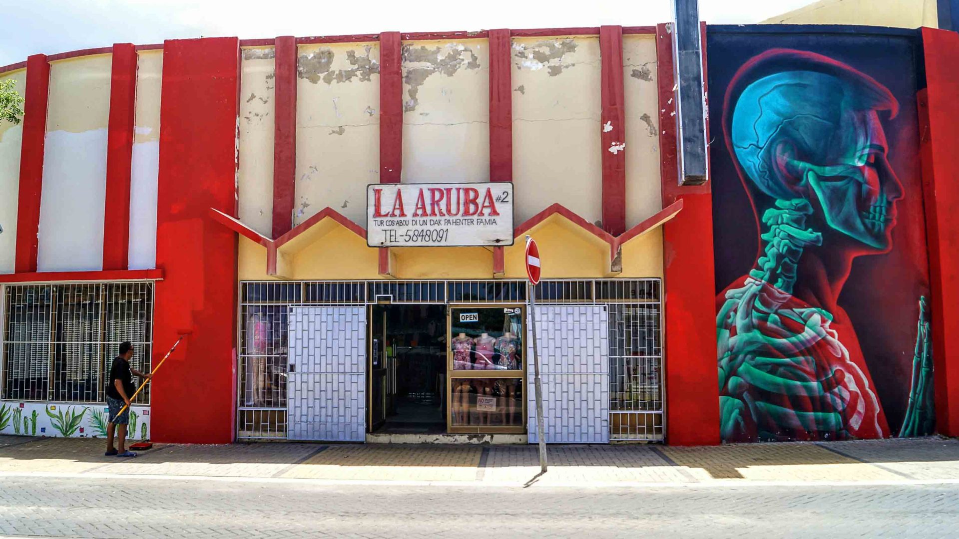 People work on a street art mural.