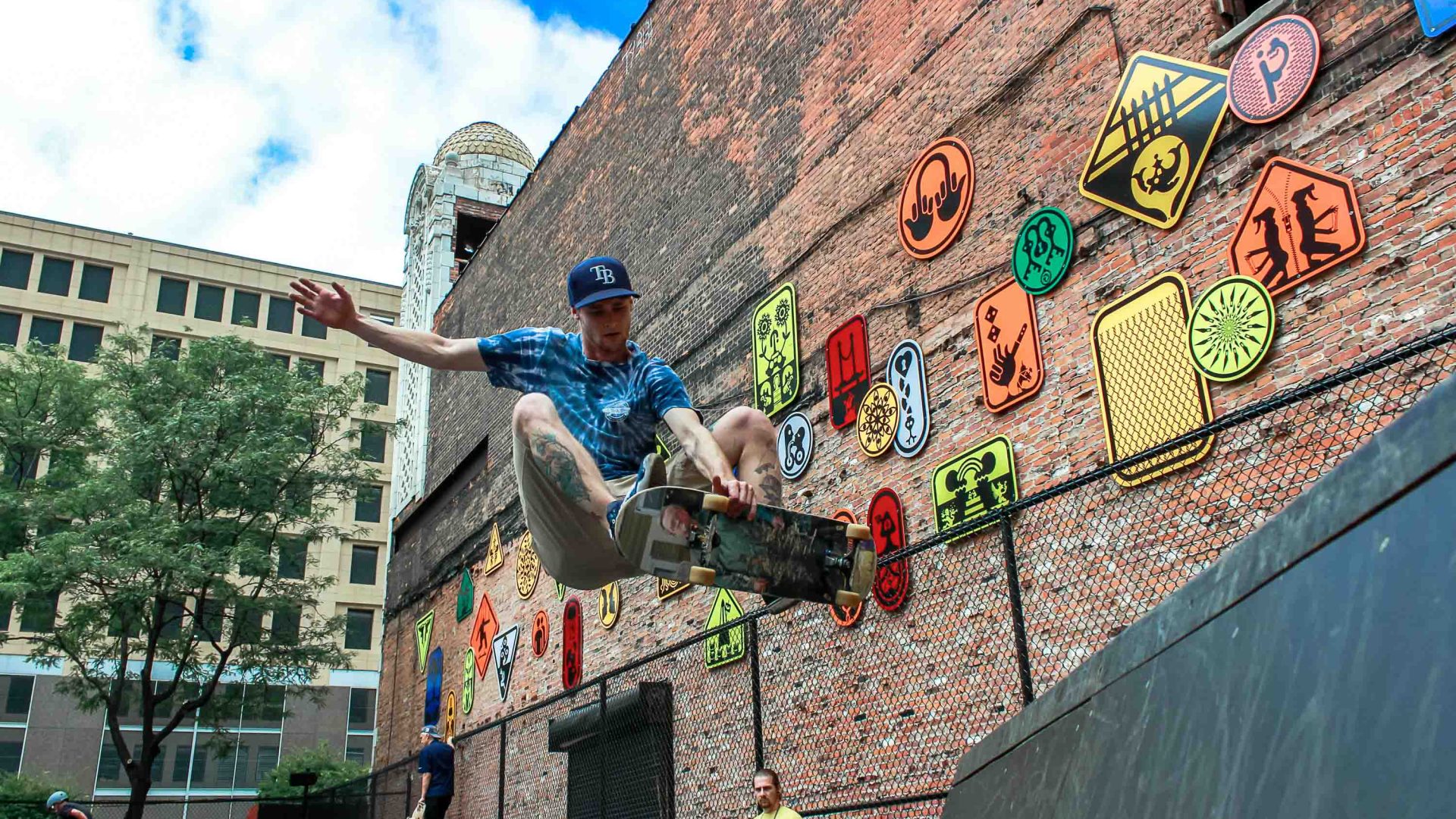 A man on a skateboard does a jump in the air.