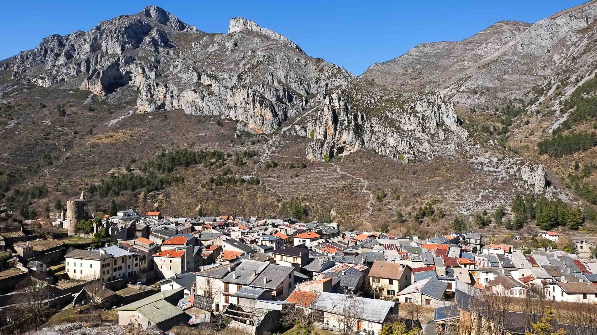 A town is nestled below some mountains.